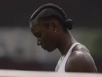 Julien Alfred road to Tokyo shown in a reflective moment on the track, capturing her struggles with pressure before triumph.