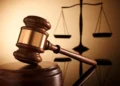 Gavel and scales of justice symbolizing the High Court case where a Carellie man pleads guilty to firearm and drug charges in Castries.