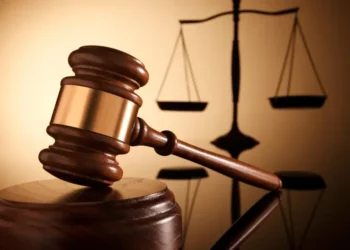 Gavel and scales of justice symbolizing the High Court case where a Carellie man pleads guilty to firearm and drug charges in Castries.