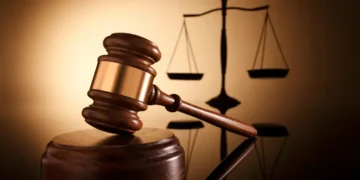 Gavel and scales of justice symbolizing the High Court case where a Carellie man pleads guilty to firearm and drug charges in Castries.