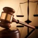 Gavel and scales of justice symbolizing the High Court case where a Carellie man pleads guilty to firearm and drug charges in Castries.