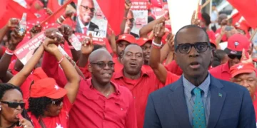 Philip J Pierre and Stanley Felix amid Labour Party crowd in Saint Lucia following betrayal remarks controversy.