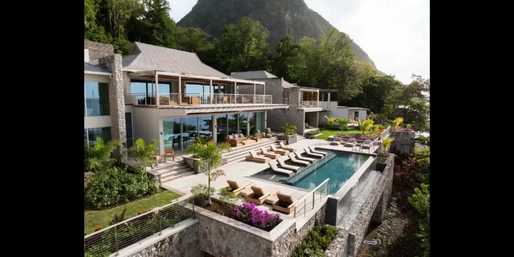 Terrace and poolside suites at Sugar Beach, A Viceroy Resort in St Lucia, with Pitons in the background – Forbes ranks best resorts in St Lucia