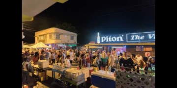 Crowd gathered at the Gros Islet Friday Night Street Party with vendors and visitors enjoying the nightlife scene.