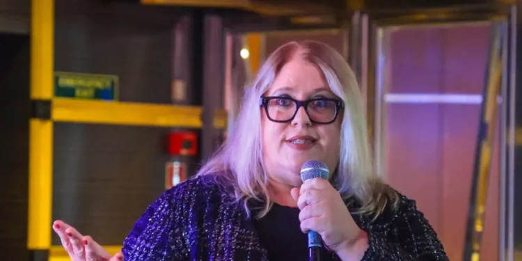 Melanie Colpitts of Aquila Center for Cruise Excellence speaking at FCCA PAMAC meeting aboard Carnival Glory.