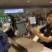 US visa bond requirement as a CBP officer reviews a traveler’s documents at an airport inspection counter