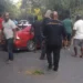 Serious accident at Ladera Gap as bystanders gather around a damaged red vehicle following a traffic crash in Soufrière