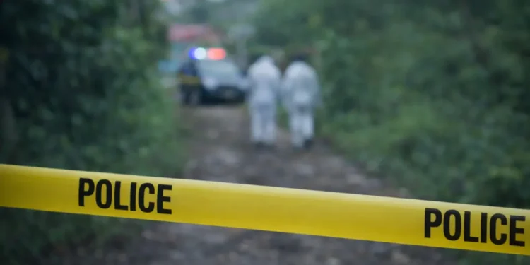 Police tape blocks access to an outdoor area in Vieux Fort during an investigation after a body found in shallow grave in Vieux Fort was reported