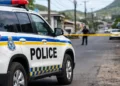 Police vehicle secures scene in Vieux Fort homicide investigation following postmortem confirmation