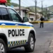 Police vehicle secures scene in Vieux Fort homicide investigation following postmortem confirmation
