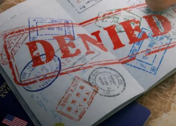 U.S. reiterates forced labor warning as a passport stamped “denied” illustrates official enforcement action