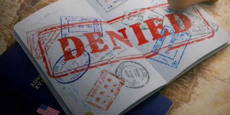 U.S. reiterates forced labor warning as a passport stamped “denied” illustrates official enforcement action