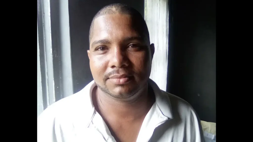 Ricky Joseph, the missing St Lucia fisherman feared killed in the Feb. 13 US military strike, pictured in a collared shirt indoors