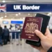 Traveler holding a UK passport and phone at UK Border control as the UK Electronic Travel Authorisation rule takes effect Feb. 25, 2026.