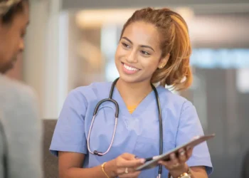 National Doctors’ Day image showing a doctor speaking with a patient in a clinical setting