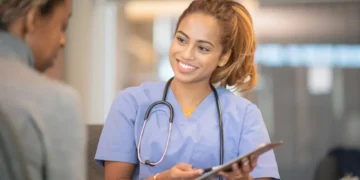 National Doctors’ Day image showing a doctor speaking with a patient in a clinical setting