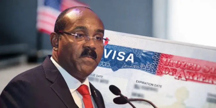 Gaston Browne urges US visa caution in a composite image showing the prime minister beside a close-up of a US visa page with a blurred American flag in the background.