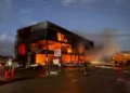 Computer World fire burns through the commercial building in Bois d’Orange as firefighters respond at night