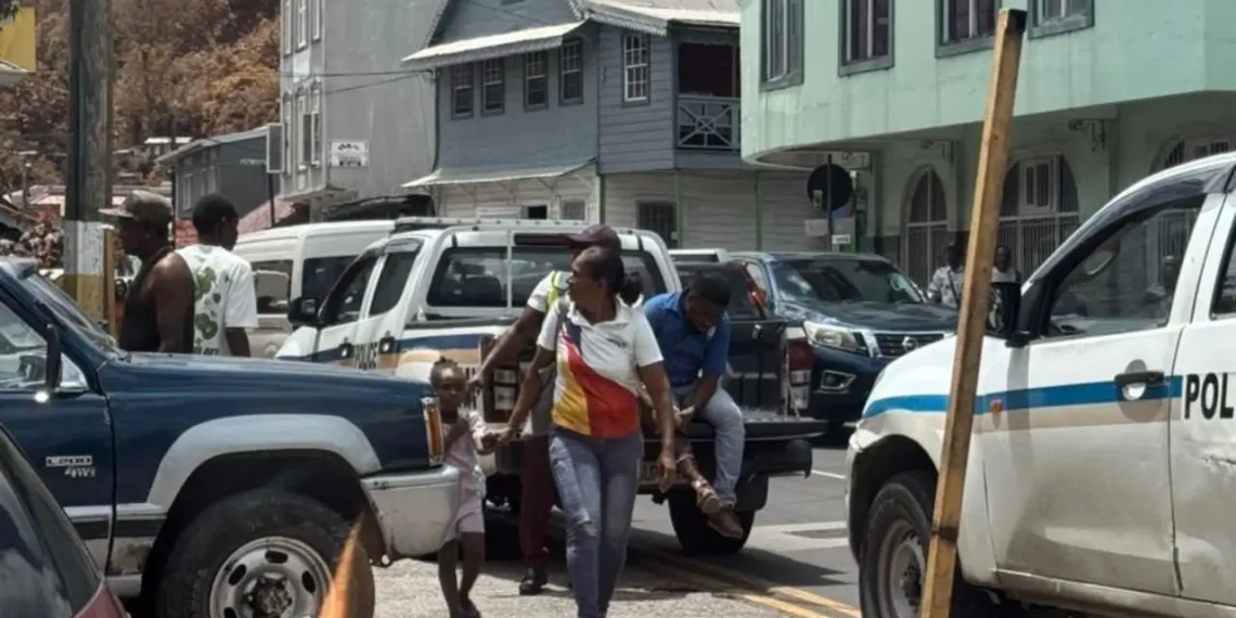 Police and residents at the scene of the Leslie Land triple shooting in Castries where three men were injured