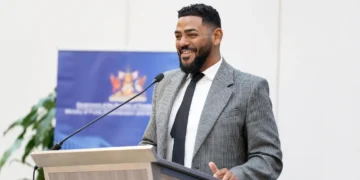 Dominic Smith Joins WEF Leadership Class as the Trinidad and Tobago minister speaks at a podium during an official event.