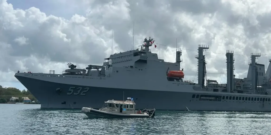 Taiwan Naval Visit in St Lucia as a Taiwanese naval vessel is escorted by a local marine security boat during port operations.