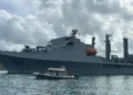 Taiwan Naval Visit in St Lucia as a Taiwanese naval vessel is escorted by a local marine security boat during port operations.
