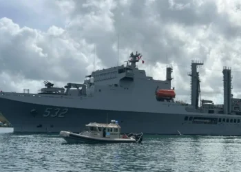 Taiwan Naval Visit in St Lucia as a Taiwanese naval vessel is escorted by a local marine security boat during port operations.