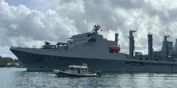 Taiwan Naval Visit in St Lucia as a Taiwanese naval vessel is escorted by a local marine security boat during port operations.