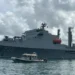 Taiwan Naval Visit in St Lucia as a Taiwanese naval vessel is escorted by a local marine security boat during port operations.
