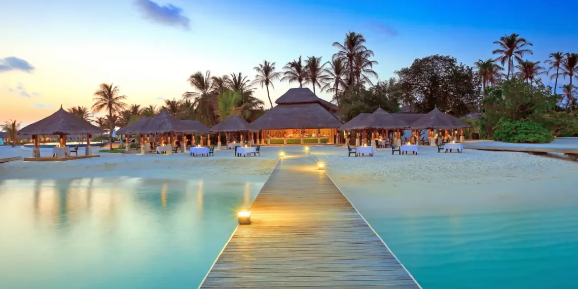 Caribbean tourism growth reflected in luxury beach resort at sunset