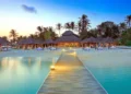 Caribbean tourism growth reflected in luxury beach resort at sunset
