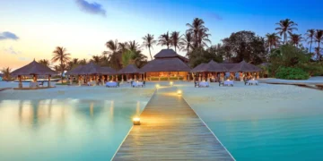 Caribbean tourism growth reflected in luxury beach resort at sunset