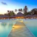 Caribbean tourism growth reflected in luxury beach resort at sunset