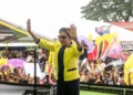 Kamla Persad-Bissessar raises both hands before supporters at a Trinidad rally as a letter to the editor addresses a Kamla Persad-Bissessar smear campaign.