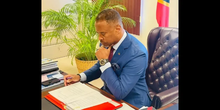 Hon Mark Brantley, Premier of Nevis, reviews documents at his desk ahead of commentary on the CARICOM dispute