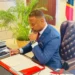 Hon Mark Brantley, Premier of Nevis, reviews documents at his desk ahead of commentary on the CARICOM dispute