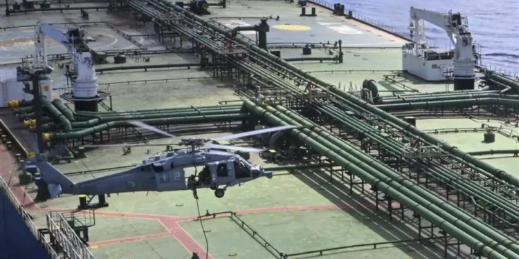 US Navy helicopter hovers over the deck of the sanctioned tanker M/T Majestic X during a maritime boarding operation in the Indian Ocean.