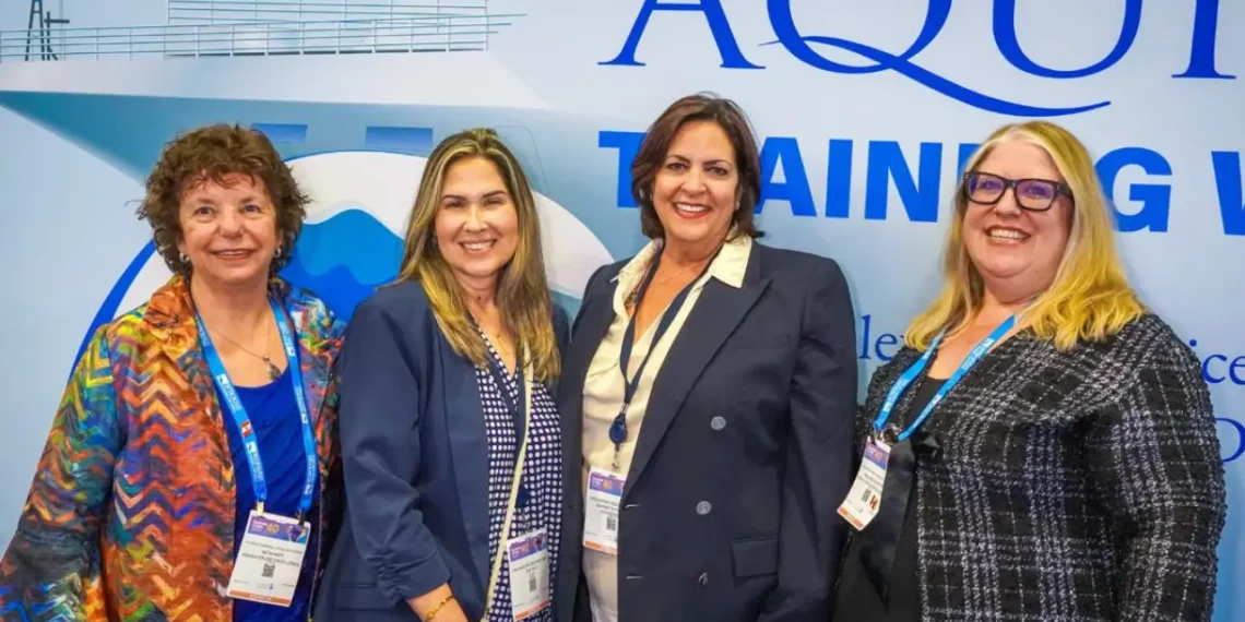 Aquila founder Beth Hatt and Vice President Melanie Colpitts with cruise executives at Seatrade Cruise Global 2026