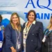 Aquila founder Beth Hatt and Vice President Melanie Colpitts with cruise executives at Seatrade Cruise Global 2026