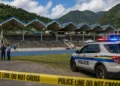 Illustration of Soufriere Stadium shooting scene with police tape and a police vehicle outside the Mini Stadium following the attack that injured two men