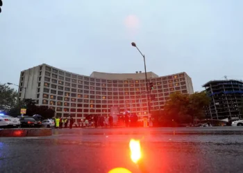 Police vehicles with emergency lights outside the Washington Hilton after a shooting at the White House Correspondents Dinner on April 25 2026