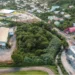 Aerial view of Bois d'Orange St Lucia where a fer-de-lance bite was reported on May 7 2026 showing dense tropical vegetation between commercial buildings and residential homes.