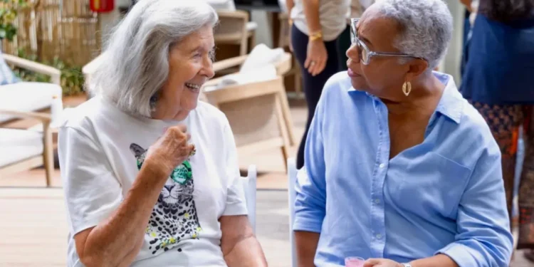 Two cancer survivors share a moment of connection at the Health City Cayman Islands Cancer Survivors Wellness Retreat.