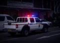 Royal St Lucia Police Force vehicle responding to a Castries parking lot shooting at night.