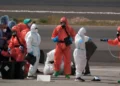 MV Hondius passengers sprayed with disinfectant by Spanish officials at Tenerife airport during the hantavirus cluster response.