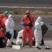 MV Hondius passengers sprayed with disinfectant by Spanish officials at Tenerife airport during the hantavirus cluster response.