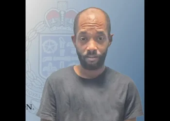 Official police charge graphic showing Joshua Paul after a Massade shooting murder charge was filed in the fatal Gros Islet case.
