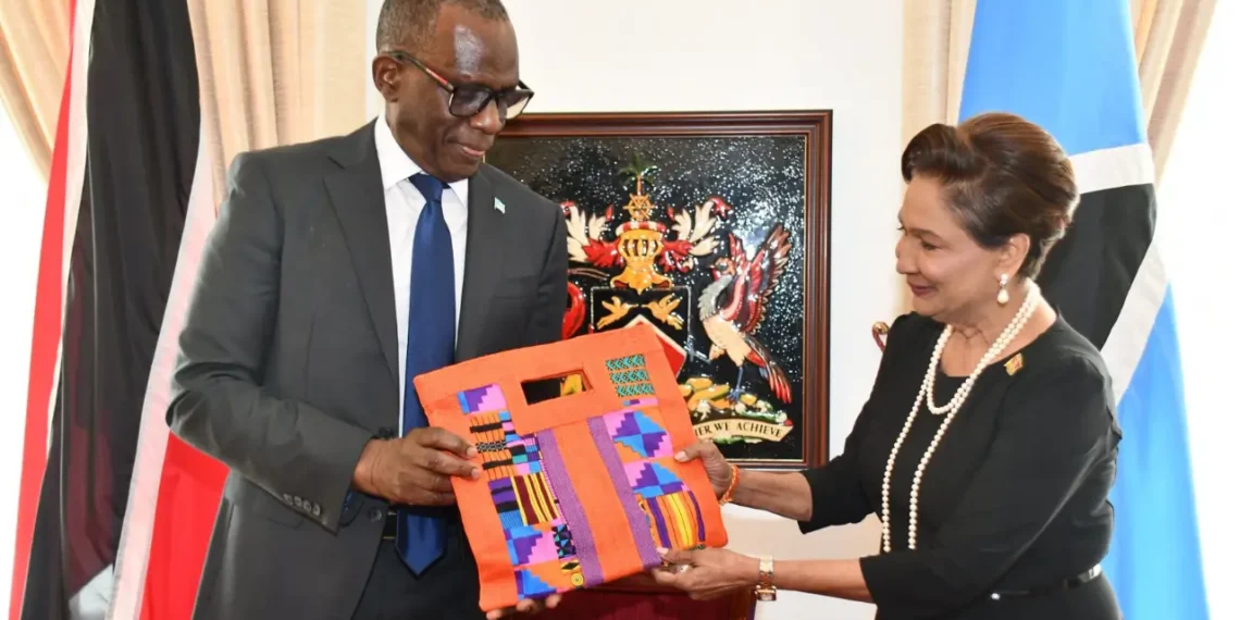 Pierre Persad-Bissessar talks open with ceremonial gift exchange at the Diplomatic Centre in Port of Spain, April 30, 2026, with Saint Lucia and Trinidad and Tobago flags in the background.