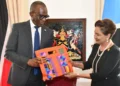 Pierre Persad-Bissessar talks open with ceremonial gift exchange at the Diplomatic Centre in Port of Spain, April 30, 2026, with Saint Lucia and Trinidad and Tobago flags in the background.