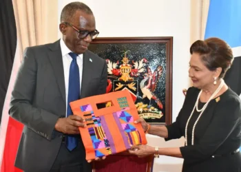 Pierre Persad-Bissessar talks open with ceremonial gift exchange at the Diplomatic Centre in Port of Spain, April 30, 2026, with Saint Lucia and Trinidad and Tobago flags in the background.